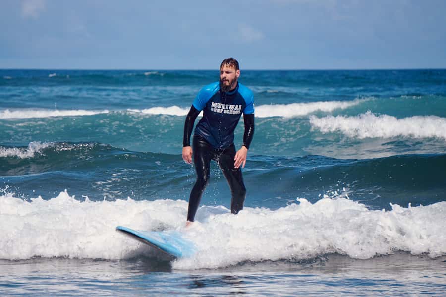Auckland: Group Surfing Lesson with Muriwai Surf School - The first 30 minutes: board basics and standing up