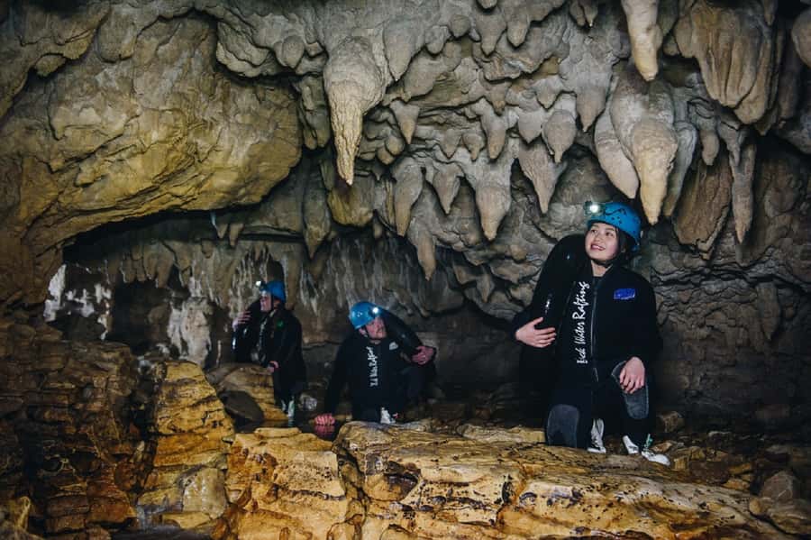 Waitomo Caves: Labyrinth Black Water Rafting Experience - Waterfalls, rock slides, and the underground river